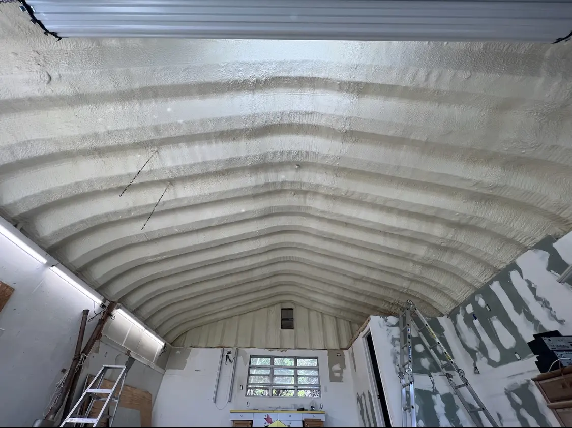 Spray polyurethane foam applied to the underside of a metal roof deck in Taylors